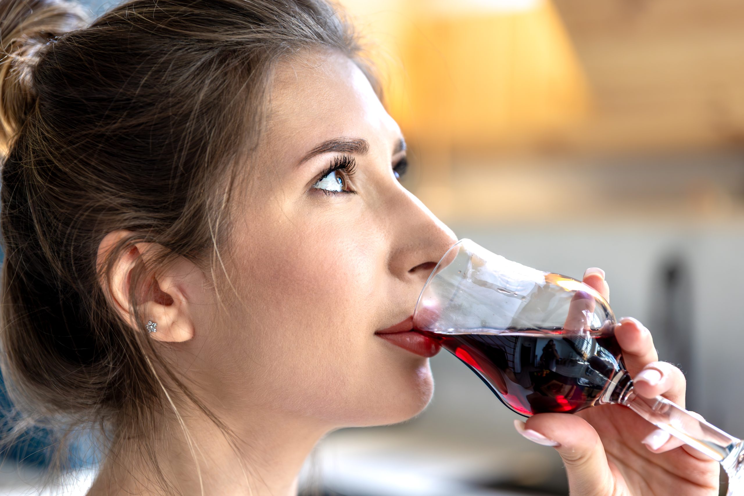 Woman enjoying wine. Peaceful moment. Red wine tasting